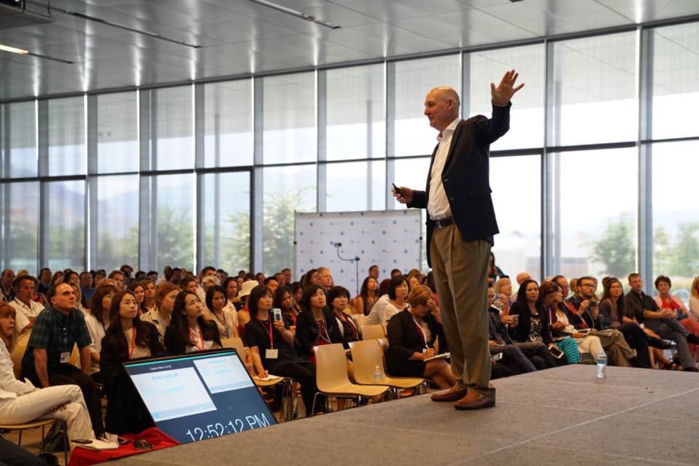 Brent Bryson speaking on stage to a full room of distributors